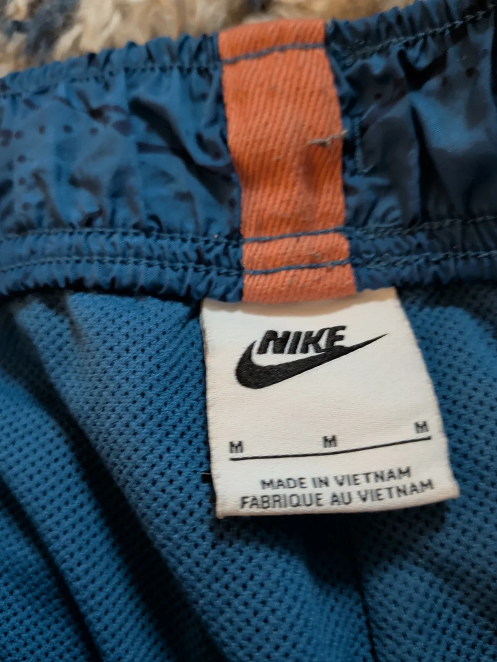 Nike Blue Athletic Shorts with Orange Accent